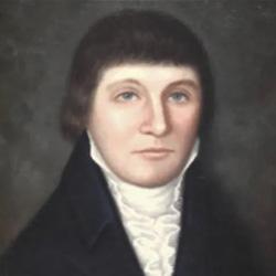 Portrait of a person with short brown hair, blue eyes, and wearing dark clothing with a high white collar.