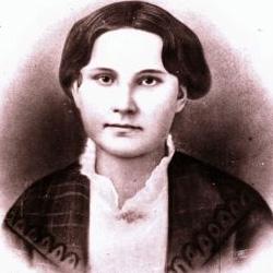 Black and white portrait of a woman with dark hair, wearing a jacket over a high-collared blouse.